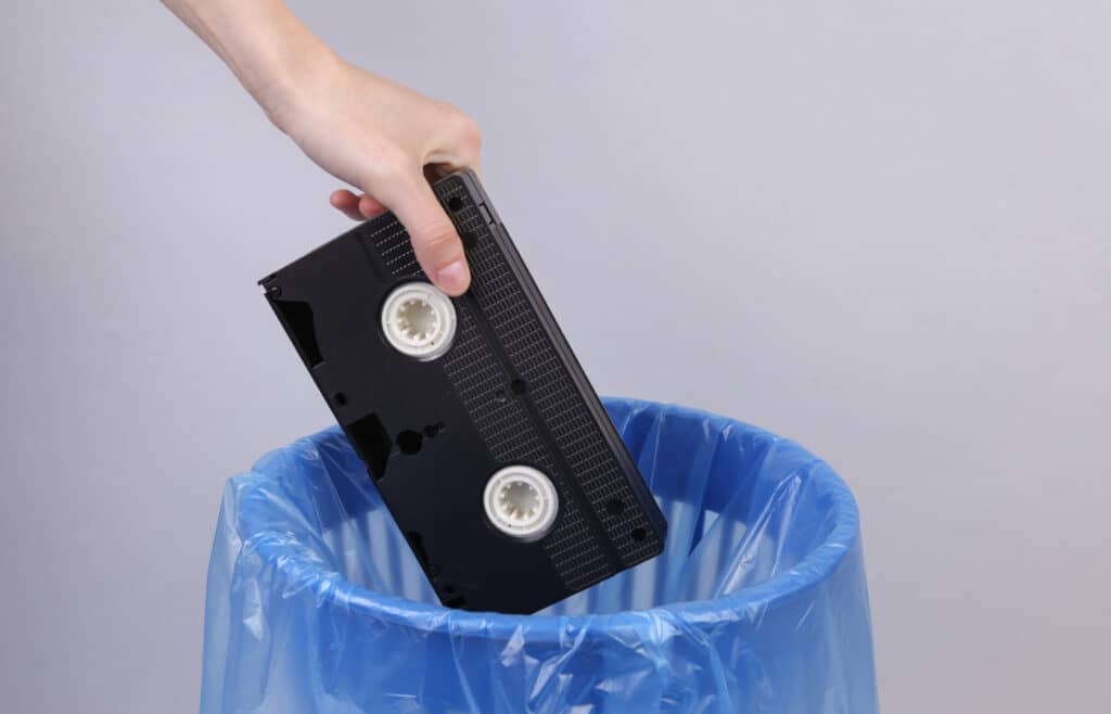 VHS tape being placed in trash